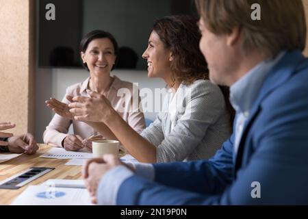 Positive business professionals brainstorming on project, discussing marketing strategy Stock Photo
