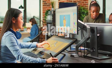 Artistic graphic designer working with touchscreen monitor to edit images, using tablet and stylus pen. Photographer editing photos to create professional content, retouching software. Stock Photo
