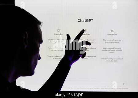 Man silhouette points on ChatGPT screen . ChatGPT is AI chatbot which is made by OpenAI Stock Photo