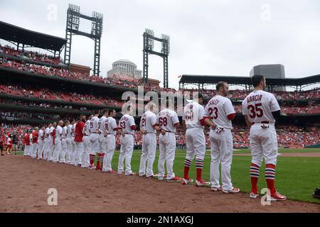 St. Louis Cardinals stand for the National Anthem, wearing pink