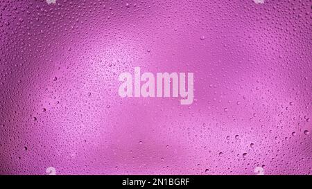 Glowing purple background with contrasting water drops. Stock Photo