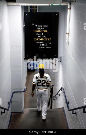 FILE - Pittsburgh Pirates' Andrew McCutchen holds the team's home run sword  as he celebrates in the dugout with teammates after hitting a solo home run  against the Seattle Mariners Friday, May