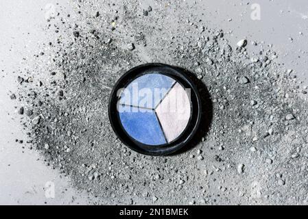 Round Box with blue eye shadows on crushed grey powder with glitter Stock Photo