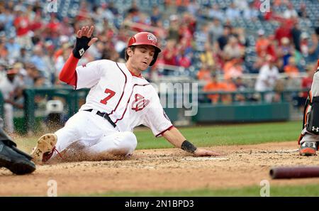 Washington Nationals' Trea Turner slides safely into third base as