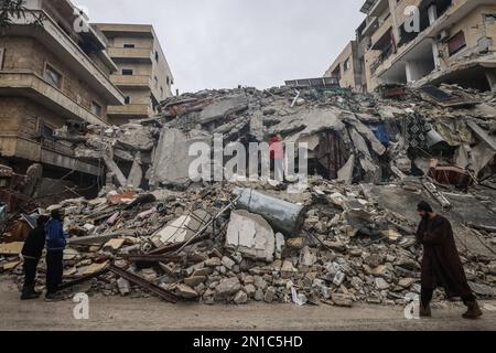 Idlib, Syria. 06th Feb, 2023. Syrian civilians inspect a destroyed residential building after the magnitude 7.8 earthquake that hit northern Syria. Credit: Anas Alkharboutli/dpa/Alamy Live News Stock Photo