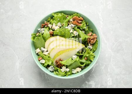 Tasty salad with pear slices on light grey marble table, top view Stock Photo
