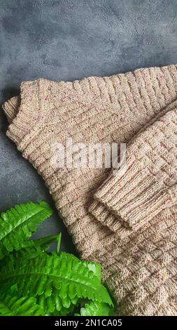 Knitted handmade items. Knitted fabric from colored thread. Bright background. copy space Stock Photo