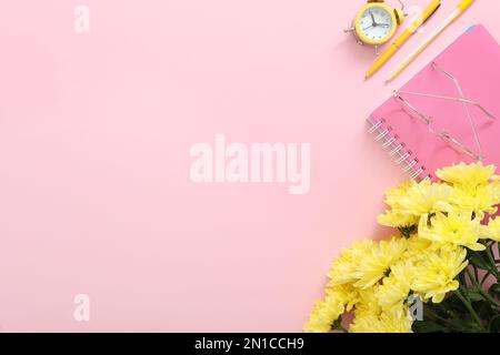 Beautiful flowers and stationery on pink background, flat lay with space for text. Teacher's Day Stock Photo