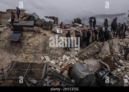 Idlib, Syria. 06th Feb, 2023. Syrian civilians inspect a destroyed residential building following a magnitude 7.8 earthquake that hit Syria. Credit: Anas Alkharboutli/dpa/Alamy Live News Stock Photo