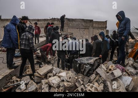 Idlib, Syria. 06th Feb, 2023. Syrian civilians and members of the White Helmets work to save people trapped beneath a destroyed building following a magnitude 7.8 earthquake that hit Syria. Credit: Anas Alkharboutli/dpa/Alamy Live News Stock Photo