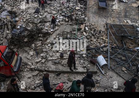 Idlib, Syria. 06th Feb, 2023. Syrian civilians inspect a destroyed residential building following a magnitude 7.8 earthquake that hit Syria. Credit: Anas Alkharboutli/dpa/Alamy Live News Stock Photo