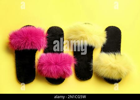 Different soft slippers on yellow background, flat lay Stock Photo