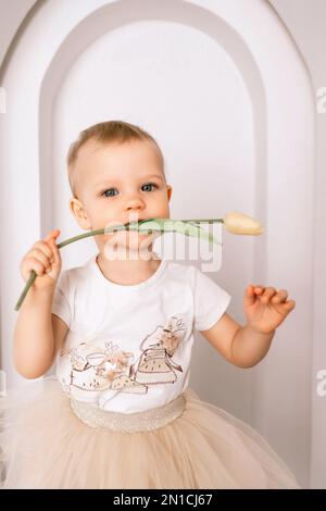 Baby girl elegant dress. A one-year-old girl in a puffy skirt and