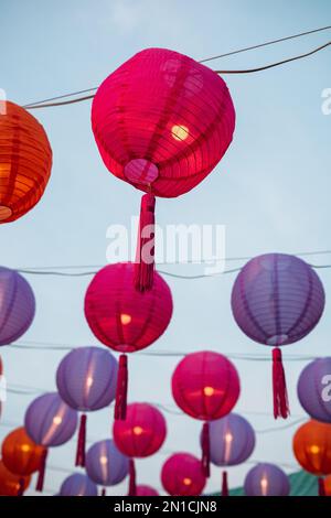 A lot of round paper lanterns hanging from wires in Bangkok Stock Photo