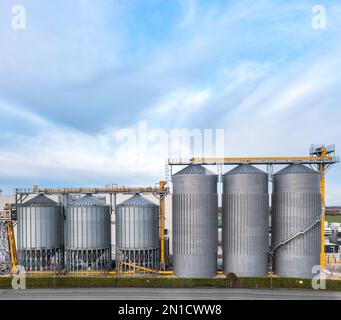 A row of large scale, industrial storage tanks or silos at a chemical plant with copy space above Stock Photo