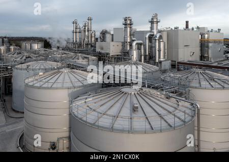 Aerial view above rows of chemical storage tanks and oil and fuel silos at an industrial site Stock Photo