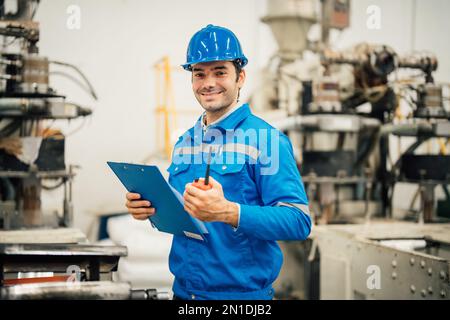 Professional Engineering of modern factory checking  to automatic machinery. Engineering with clipboard Programmable Logic Controller to manage large Stock Photo