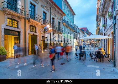 View of busy street with cafes and bars in old town Porto at dusk, Porto, Norte, Portugal, Europe Stock Photo