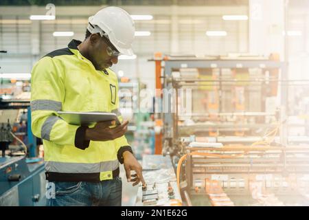 Technician working in factory check functionality while commissioning a production line, Man working Stock Photo