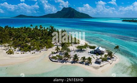 Aerial of a little islet with a white sand beach and the lagoon of Maupiti, Society Islands, French Polynesia, South Pacific, Pacific Stock Photo