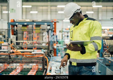 Technician working in factory check functionality while commissioning a production line, Man working Stock Photo