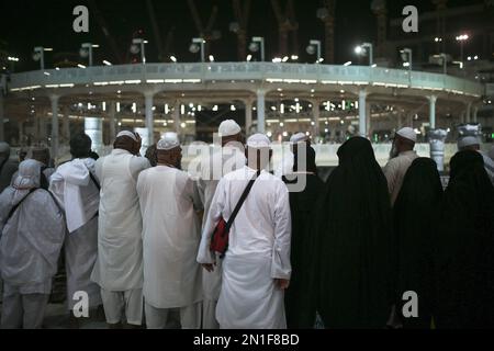 Muslim pilgrim pray while facing the Kaaba, the cubic building at the ...