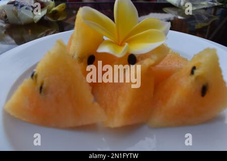 yellow watermelon pieces on a white plate Stock Photo