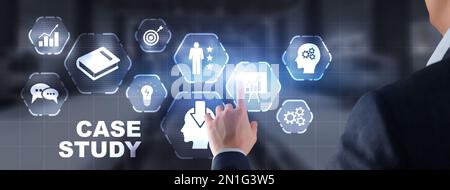 Businessman pressing case study button on virtual screens Stock Photo