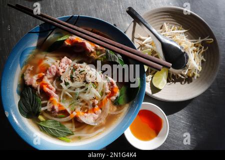 Bowl of Vietnamese traditional pho chicken noodle soup in a street restaurant, Tan Chau, Vietnam, Indochina, Southeast Asia, Asia Stock Photo