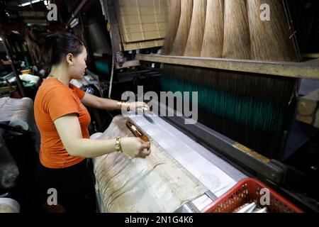 A traditional silk factory, woman working on an old silk loom, Tan Chau, Vietnam, Indochina, Southeast Asia, Asia Stock Photo