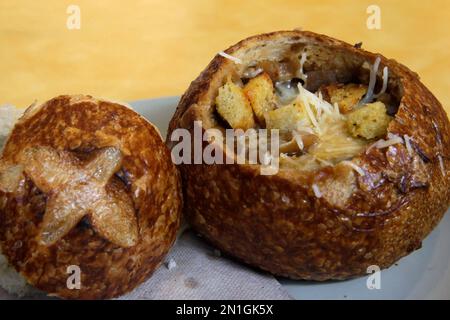 FILE - This June 9, 2015, file photo, shows a Bistro French Onion Soup Bread Bowl at a Panera bread restaurant in New York. The city Board of Health voted unanimously Wednesday, Sept. 9 to require chain eateries to put salt-shaker symbols on menus to denote dishes with more than the recommended daily limit of 2,300 milligrams of sodium. A Bistro French Onion Soup Bread Bowl contains more sodium than the recommended daily limit, which is equal to about 1 teaspoon of salt. (AP Photo/Mary Altaffer, File)