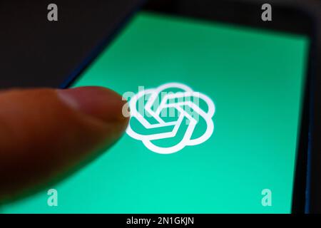 Using an OpenAI app by ChatGPT on phone screen concept image Stock Photo