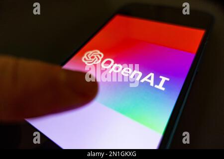 Using an OpenAI app by ChatGPT on phone screen concept image Stock Photo