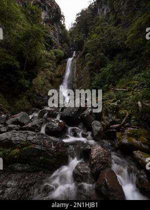 Avalanche creek waterfall long exposure, idyllic river cascade in lush green nature at Arthurs Pass National Park Canterbury South Island New Zealand Stock Photo