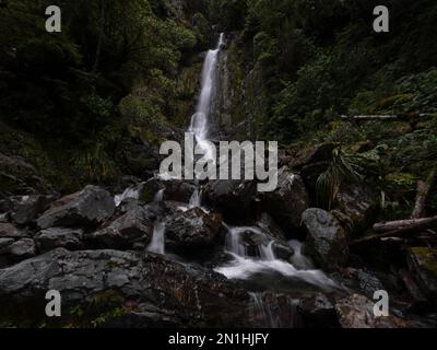 Avalanche creek waterfall long exposure, idyllic river cascade in lush green nature at Arthurs Pass National Park Canterbury South Island New Zealand Stock Photo