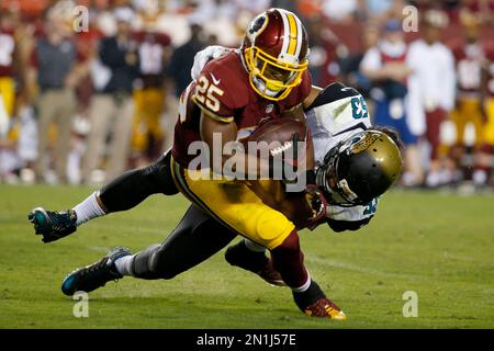 Washington Redskins running back John Riggins (44) with a host of Detroit  Lions defenders hanging on makes a gain in NFC play-off action between the  Lions and Skins, Saturday, Jan. 8, 1983