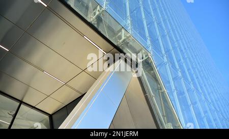 Combination of metal and glass wall material. Steel facade on columns. Abstract modern architecture. High-tech minimalist office building. Contemporar Stock Photo