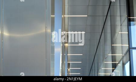 Combination of metal and glass wall material. Steel facade on columns. Abstract modern architecture. High-tech minimalist office building. Contemporar Stock Photo