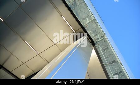 Combination of metal and glass wall material. Steel facade on columns. Abstract modern architecture. High-tech minimalist office building. Contemporar Stock Photo