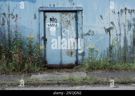 Fire Exit door on the exterior of a factory building, UK Stock Photo