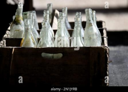 Local winery empty wine bottles in an antique wooden crate. Stock Photo