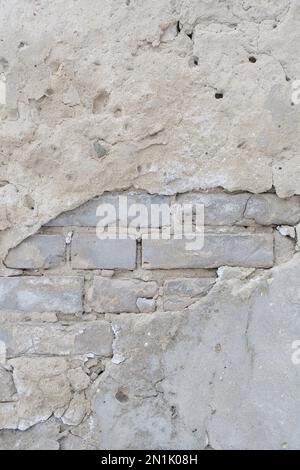 Old brick wall with peeling plaster Stock Photo