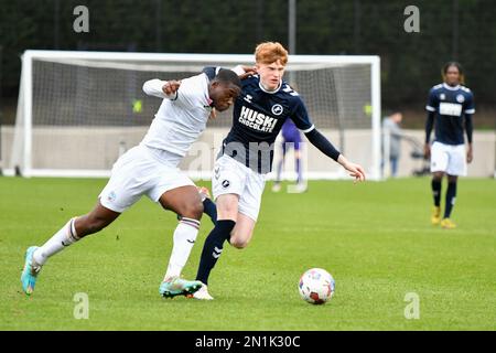 Swansea, Wales. 4 February 2023. Geoffroy Bony of Swansea City battles for  possession with Kyron Horsley-McKay of Millwall during the Professional  Development League game between Swansea City Under 18 and Millwall Under