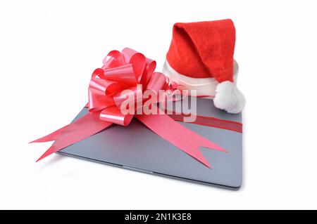 Close-up of laptop computer christmas gift with a ribbon isolated on a white background Stock Photo