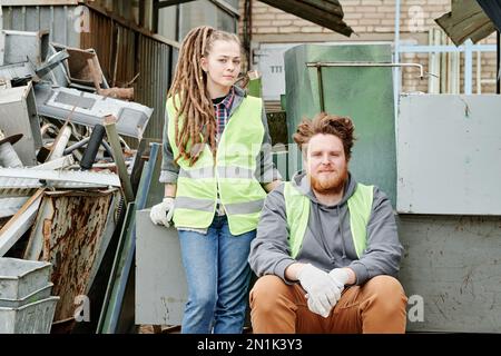 Couple in neon vests working at materials recovery facility Stock Photo