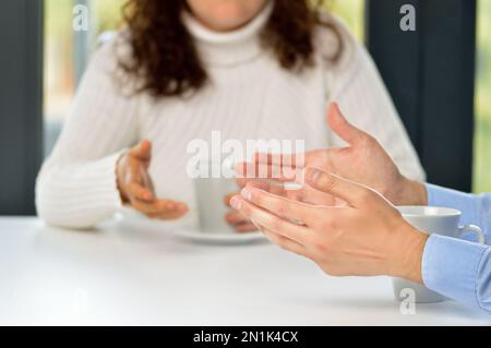 Two friends hands talking in a bar Stock Photo