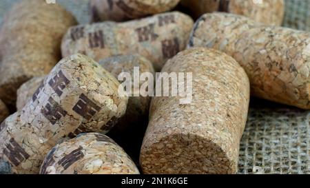 Different champagne or wine corks on from wine bottles on burlap fabric an be used as background. Selective focus. Close up. Stock Photo