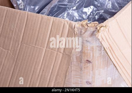 Battered cartboard box isolated on a white background Stock Photo