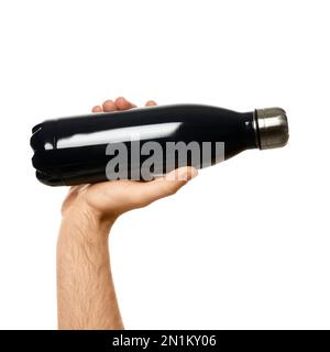 Man holding black thermos bottle on white background, closeup Stock Photo