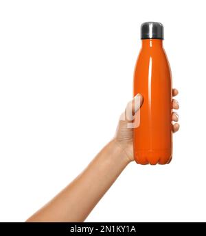 Woman holding orange thermos bottle on white background, closeup Stock Photo